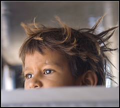Kid peeking up from the back of a bus.jpg
